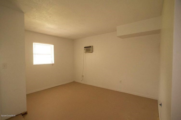 A room with a window and a white ceiling.