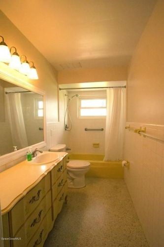 A bathroom with a sink, toilet, and shower.