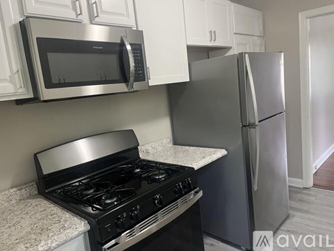 A room with a wooden floor and a white door.