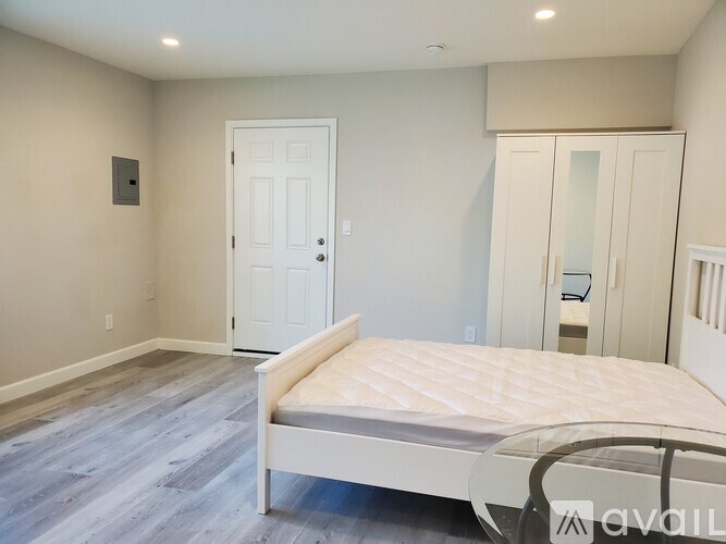 A bedroom with a bed, dresser, and closet.