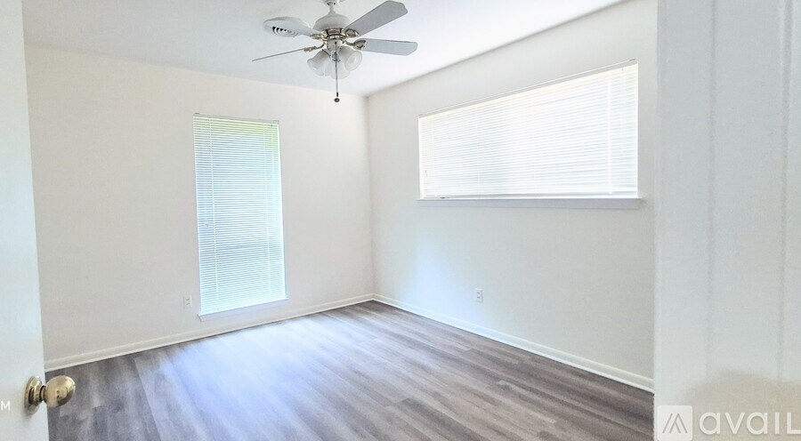 A kitchen with a granite countertop and white cabinets.