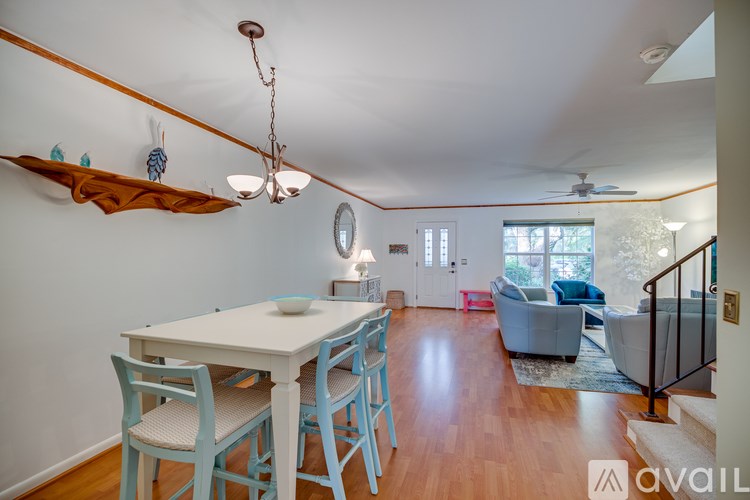 A dining room with a white table and blue chairs.
