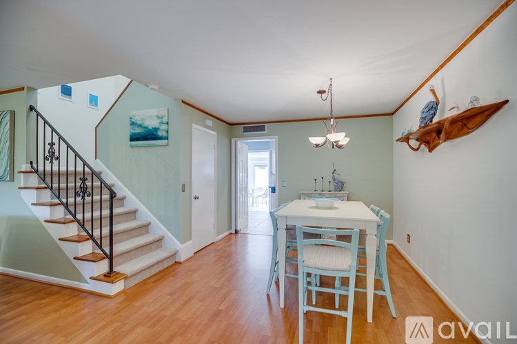 A dining room with a white table and blue chairs.