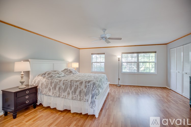 A bedroom with a bed, dresser, and window.