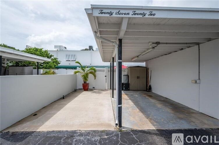 A white building with a sign that says "Forty Seven Twenty Two" on the roof.