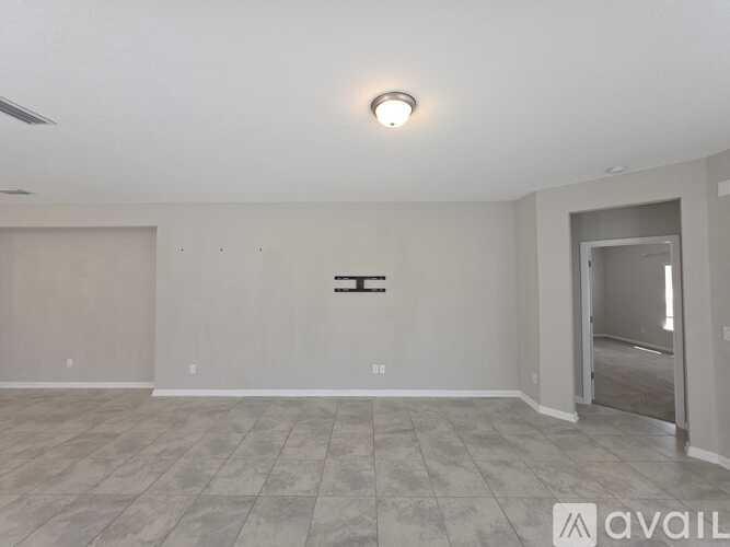 A spacious room with a tiled floor and a ceiling light.