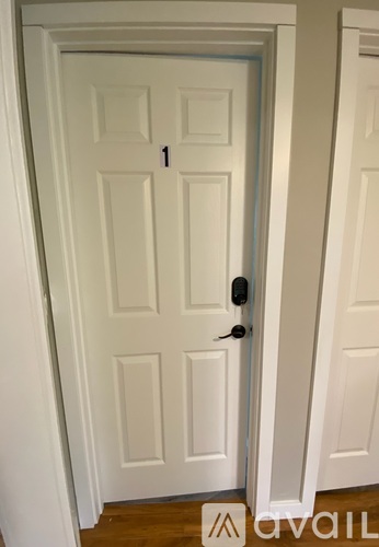 A white door with a black handle and a number 1 on it.