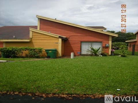 A house with a red and yellow exterior is for sale.