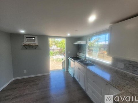A kitchen with a countertop and cabinets is available for rent.