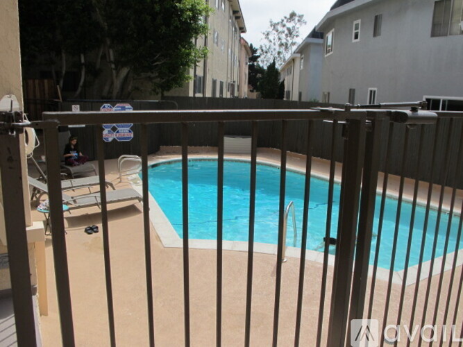 A pool surrounded by a black fence.