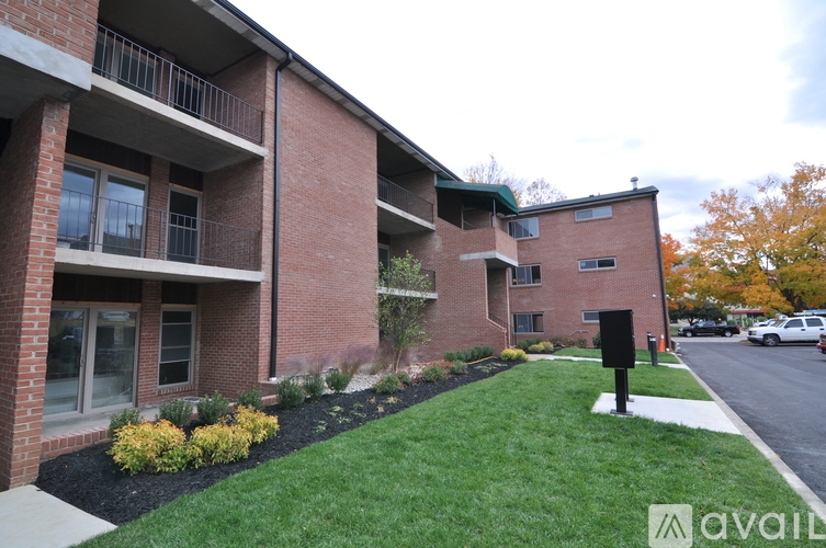 A brick building with a green lawn in front.