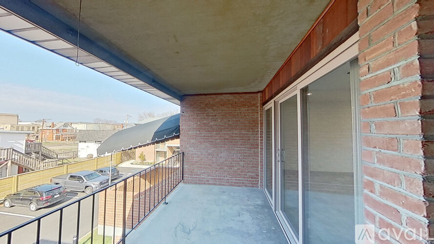 A balcony with a black railing and a glass door.