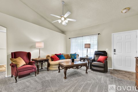 A living room with a red chair and a black chair.