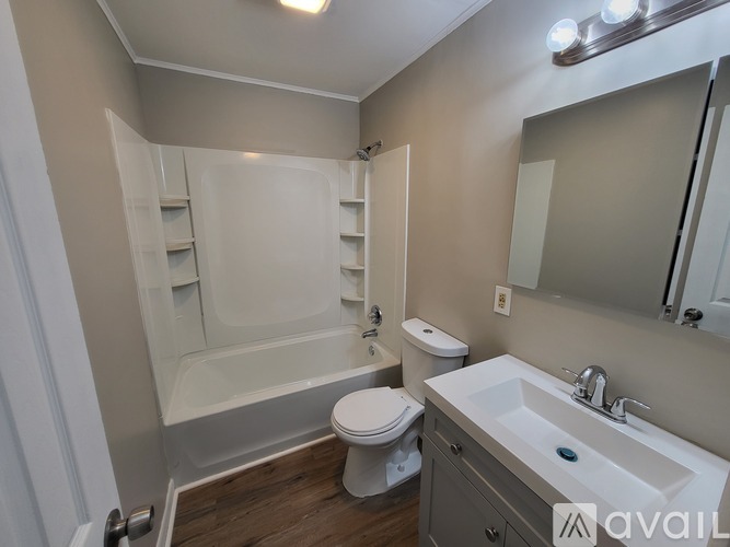 A bathroom with a toilet, sink, and bathtub.