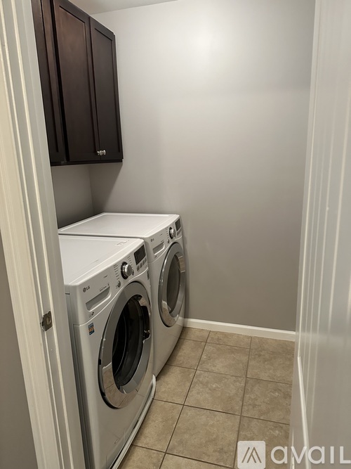 A small laundry room with a washer and dryer.