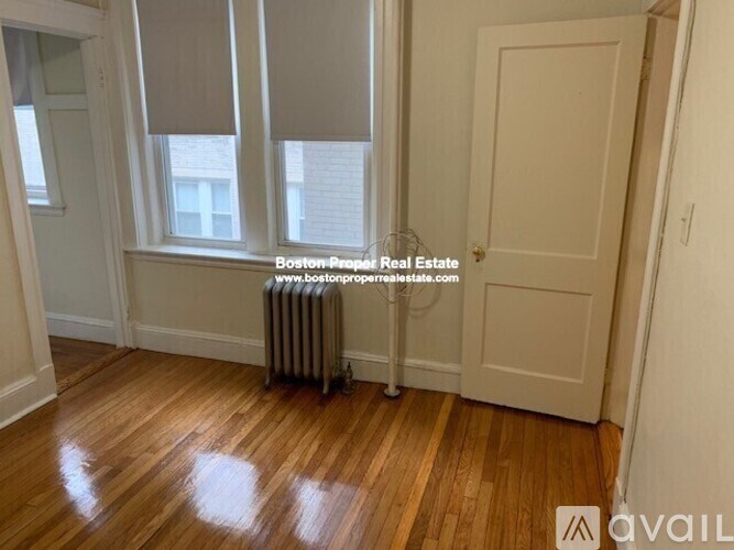 A room with wooden floors and a white door.