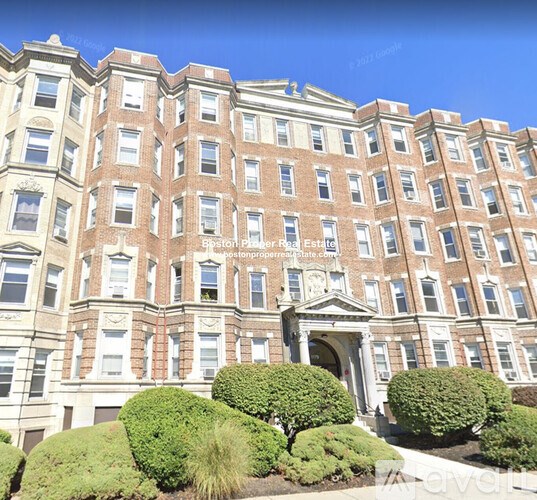 A large, multi-story building with a symmetrical facade and a central entrance.