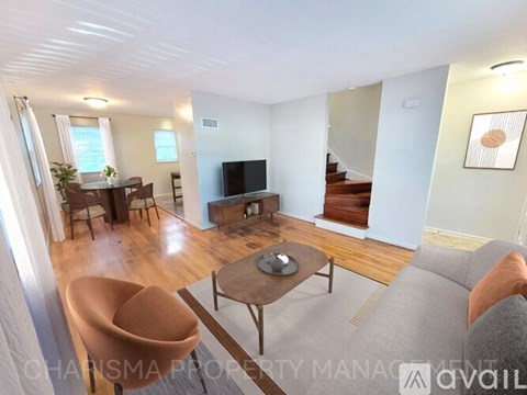 A living room with a brown chair and a grey sofa.