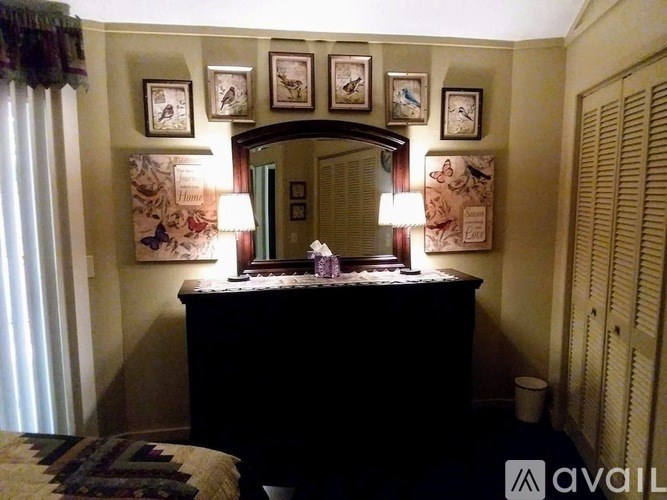 A bedroom with a dresser and a mirror.