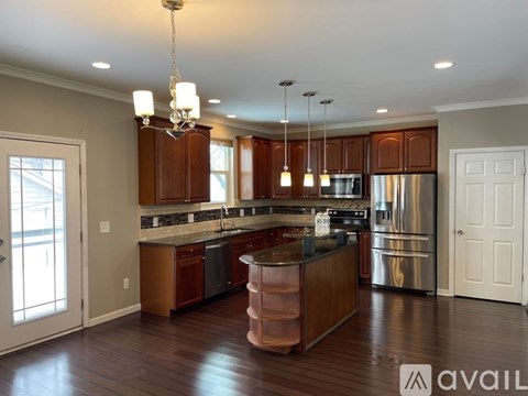 A modern kitchen with wooden cabinets and stainless steel appliances.