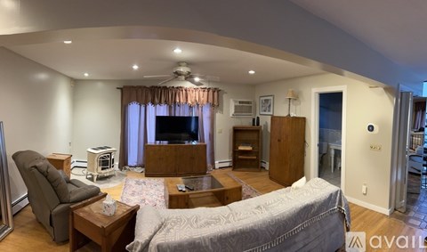 A living room with a grey couch and a brown coffee table.