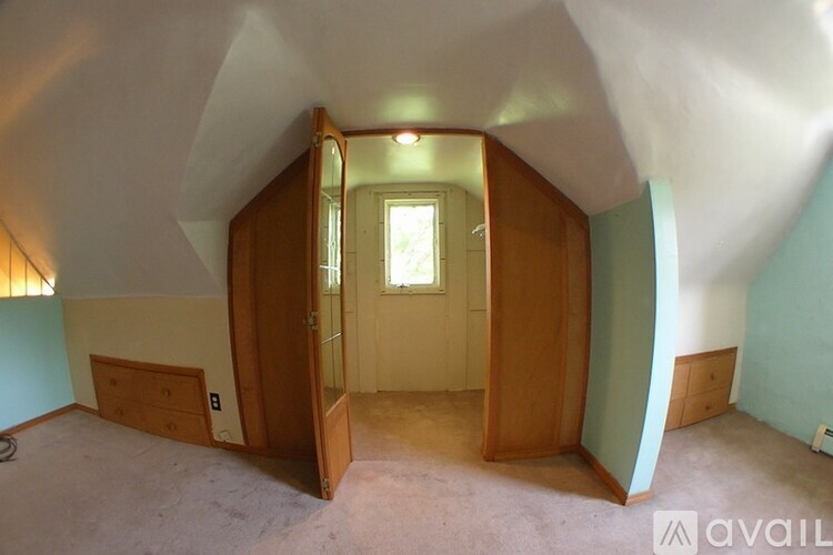 A room with a window and a door is available for rent.