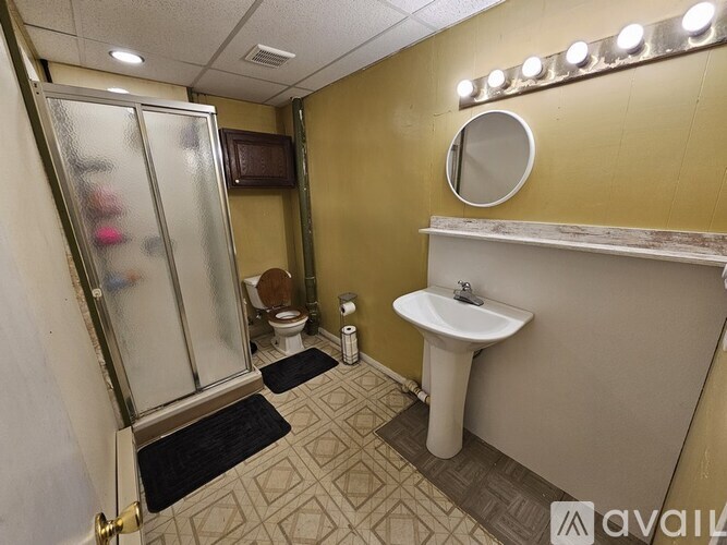 A bathroom with a sink, toilet, and shower.
