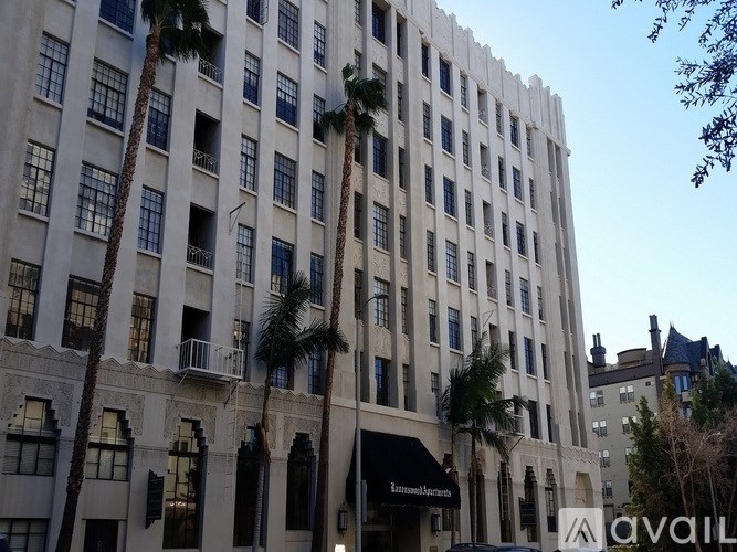 A tall building with a sign that says "AVAILABLE" in front of it.