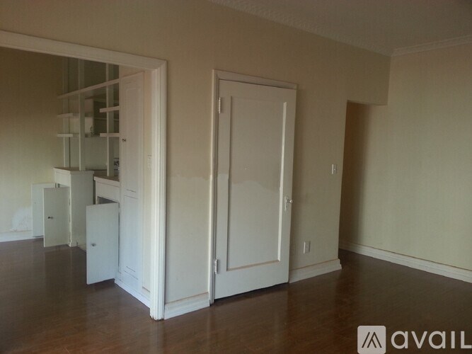 A room with a white door and a white cabinet.