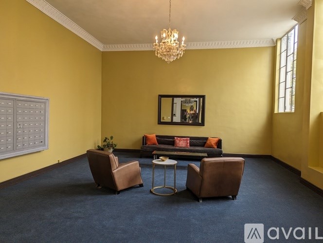 A living room with a sofa, two chairs, and a coffee table.