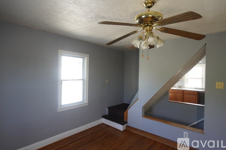 A room with a ceiling fan and a window.