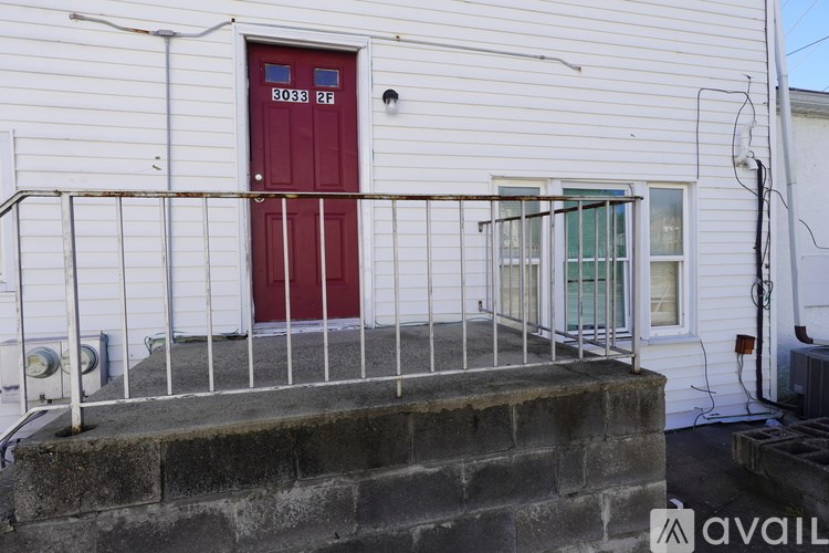 A red door with the number 5083 217 on it.