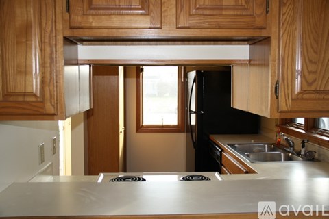 A kitchen with wooden cabinets and a stove top.