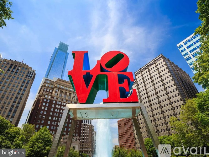 A large LOVE sculpture in the middle of a city.