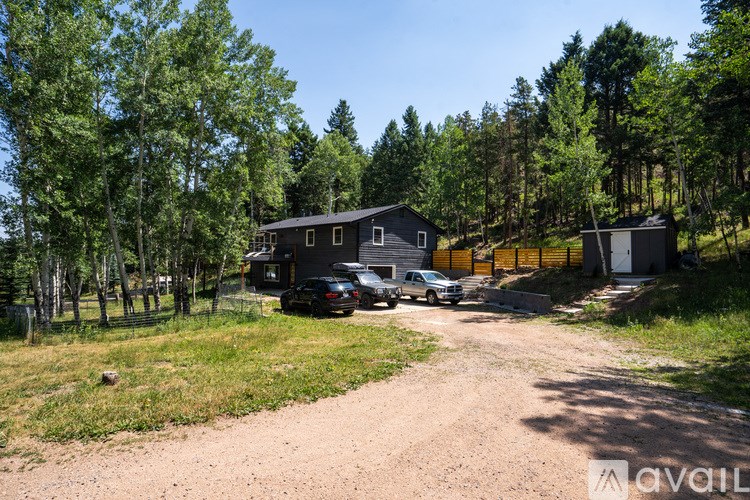 A house with a driveway and a car parked in front.