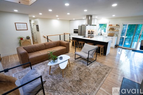 A living room with a brown sofa and a white coffee table.
