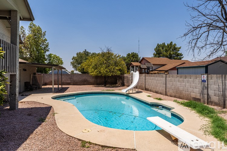 A small residential pool with a slide.