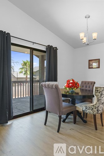 A dining room with a table and chairs and a chandelier.