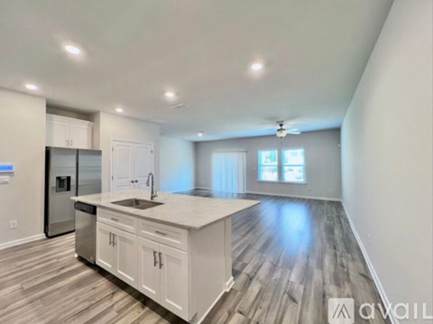 A modern kitchen with white cabinets and a central island.