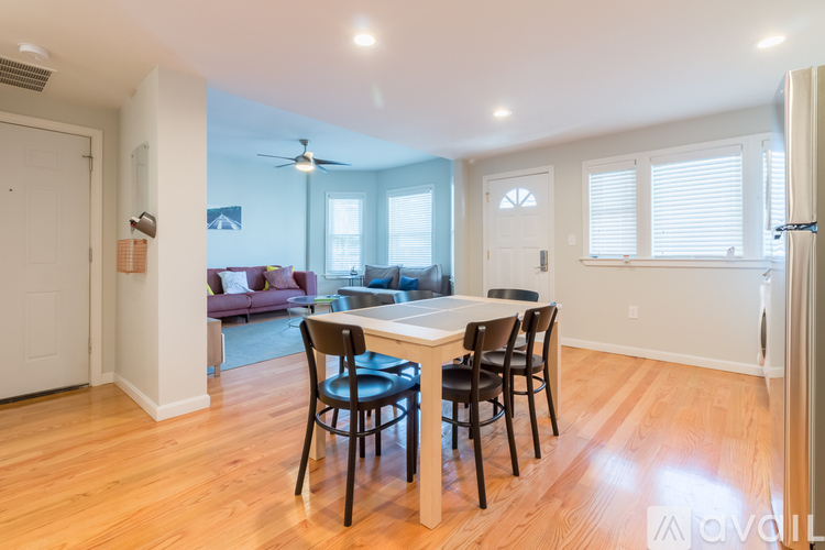 A dining room with a table and chairs.