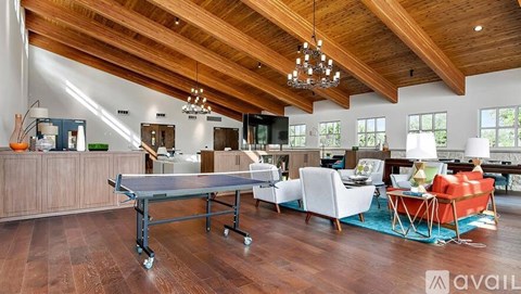 A large open living room with a dining table and chairs.