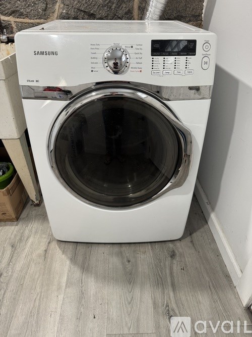 A white Samsung washing machine with the door open.