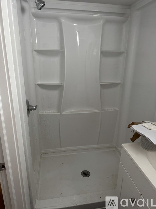 A white bathroom with a walk in shower.