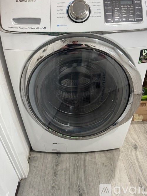 A Samsung washing machine with the door open.
