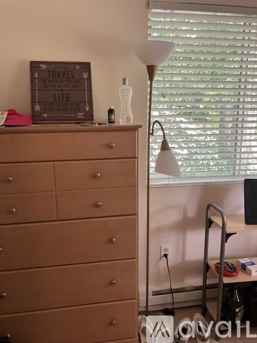 A brown chest of drawers with a sign that says "Travel Life" on top.