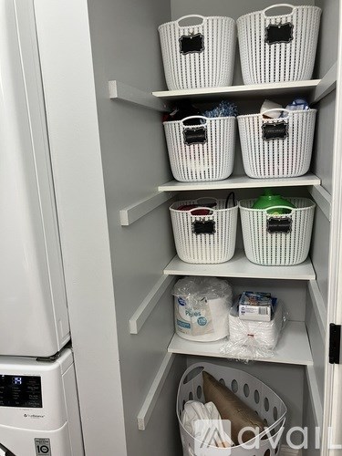 White baskets on shelves of a white refrigerator.