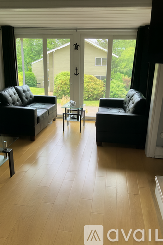 A kitchen with a wooden table and chairs in front of a welcome sign.