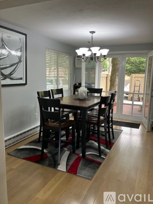 A dining room with a table set for six.
