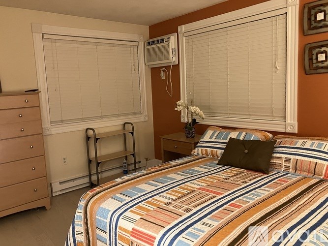 A kitchen with white appliances and a wooden table.