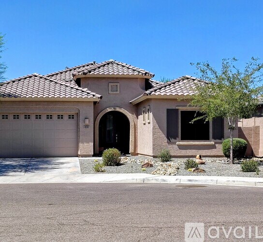 A house with a tiled roof and a garage door.